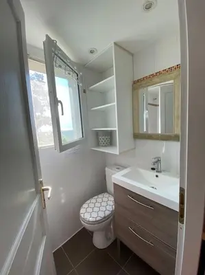 a small bathroom with a toilet and a sink at Tranquillité ,vue mer in Chiatra