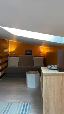 a living room with a couch and a table at Tranquillité ,vue mer in Chiatra