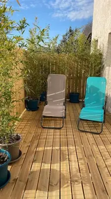 two chairs sitting on top of a wooden deck at Tranquillité ,vue mer in Chiatra