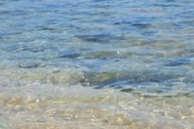 a large body of water with rocks in it at F2 pieds dans l'eau in Casaglione