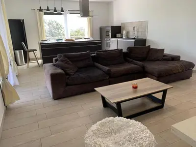 a living room with a couch and a coffee table at Caminu di porto vecchio***. (Piscine chauffée ) in Porto-Vecchio