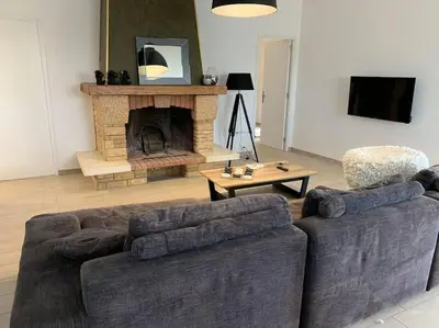 a living room with two couches and a fireplace at Caminu di porto vecchio***. (Piscine chauffée ) in Porto-Vecchio