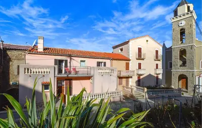 a building with a clock tower and a church at 3 Bedroom Stunning Home In Marignana in Marignana