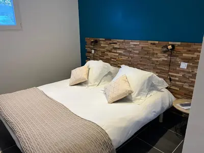a bed with white sheets and pillows on it at Umbria di Porto Vecchio*** in Porto-Vecchio