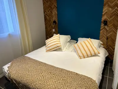a bed with two pillows on top of it at Umbria di Porto Vecchio*** in Porto-Vecchio