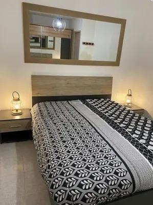 a bedroom with a large bed with a large mirror at Charmant bonheur en bord de mer in Ghisonaccia