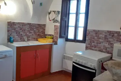 a kitchen with a sink and a stove at Gîte E Curtaline in Speloncato