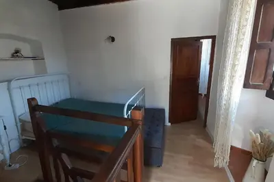 a small room with a bed and a wooden floor at Gîte E Curtaline in Speloncato
