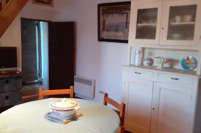 a kitchen with a table with a candle on it at Gîte E Curtaline in Speloncato