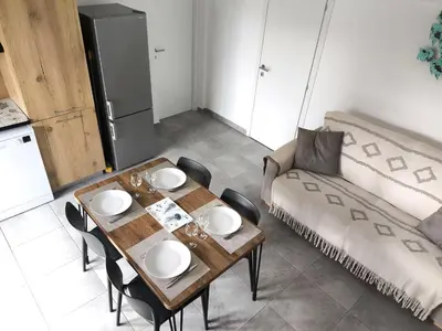 a living room with a couch and a table at Mini Villa 4-6 pers. Les hameaux de Saint Cyprien in Lecci