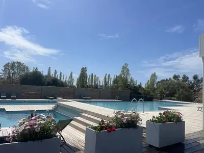 a large swimming pool with blue water at Mini Villa 4-6 pers. Les hameaux de Saint Cyprien in Lecci