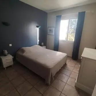 a bedroom with a large bed and a window at Villa E case di u Puntale in Ghisonaccia