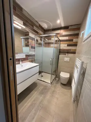 a bathroom with a glass shower and a toilet at Villa pedicervu haut in Ventiseri