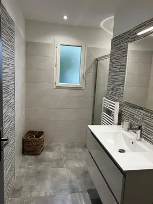 a white bathroom with a sink and a window at Villa pedicervu haut in Ventiseri