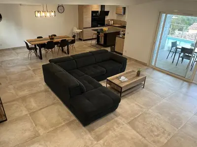 a living room with a couch and a table at Villa pedicervu haut in Ventiseri