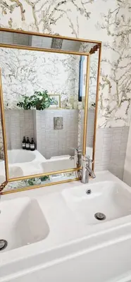 a bathroom with a white sink and a mirror at VILLA AVEC PISCINE PORTO-VECCHIO CORSICA in Porto-Vecchio