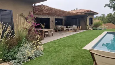 a garden with a patio and a swimming pool at VILLA AVEC PISCINE PORTO-VECCHIO CORSICA in Porto-Vecchio