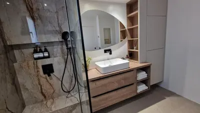 a bathroom with a sink and a shower with a mirror at VILLA AVEC PISCINE PORTO-VECCHIO CORSICA in Porto-Vecchio