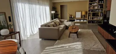 a living room with a couch and a table at VILLA AVEC PISCINE PORTO-VECCHIO CORSICA in Porto-Vecchio