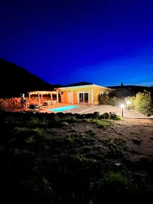 a house with a swimming pool at night at Très belle villa au calme avec piscine à Sagone in Sagone