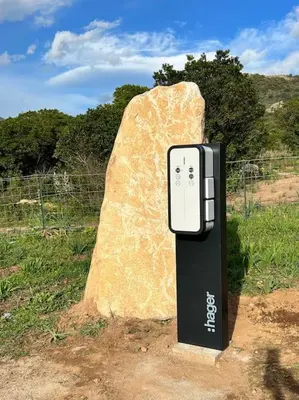 a cell phone sitting next to a large rock at Très belle villa au calme avec piscine à Sagone in Sagone