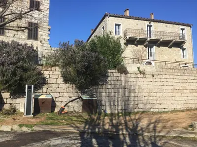 a brick wall in front of a building at A Casa Carbinesa in Carbini