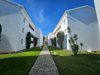 a large white building with a grass yard at Casa Johanna, plage et piscine in Moriani Plage