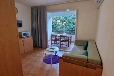a living room with a couch and a table at Casa Johanna, plage et piscine in Moriani Plage