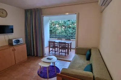 a living room with a couch and a table at Casa Johanna, plage et piscine in Moriani Plage