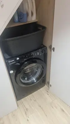 a washing machine in a cabinet in a kitchen at Villa les pieds dans l'eau résidence calme in Poggio-Mezzana
