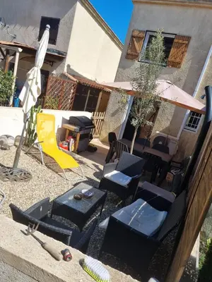 a patio with chairs and a table and a grill at Villa les pieds dans l'eau résidence calme in Poggio-Mezzana