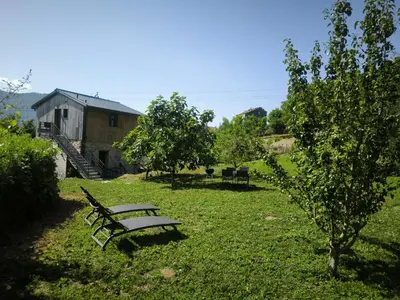 a park bench sitting in the grass in a yard at U MULINU in Moïta