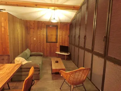 a living room with a couch and a table at U MULINU in Moïta