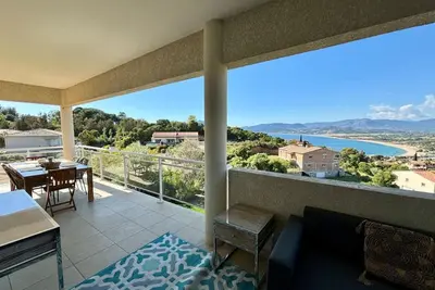 a room with a balcony with a view of the ocean at Casamea - Vue mer, Terrasse, Clim, Proche Plage in Porticcio