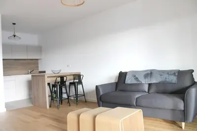 a living room with a couch and a table at Appartement moderne à Grosseto-Prugna, vue montagne, 50 m² in Grosseto-Prugna