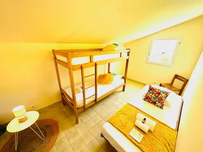 a living room with a bunk bed and a couch at Appartement front de mer et piscines in Ghisonaccia