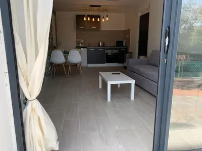 a living room with a couch and a table at bellucciu di porto vecchio***. (Piscine chauffée) in Porto-Vecchio