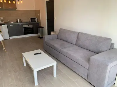 a living room with a couch and a table at bellucciu di porto vecchio***. (Piscine chauffée) in Porto-Vecchio