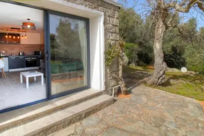 a large window of a house with a patio at bellucciu di porto vecchio***. (Piscine chauffée) in Porto-Vecchio