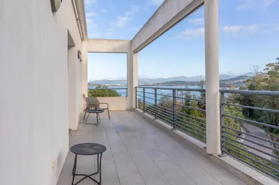 a balcony with a view of the water at Les Terrasses de la Pinède - Appt climatisé in Coti-Chiavari
