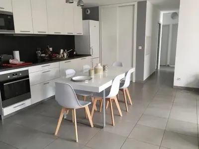 a kitchen with a white table and chairs at Les Terrasses de la Pinède - Appt climatisé in Coti-Chiavari