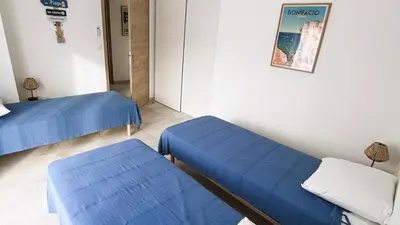 a hospital room with blue beds and a poster on the wall at Villa Copains, 5 pers, piscine chauffée, 5 mn plage in Cirendinu