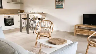 a living room with a couch and chairs and a table at Villa Copines, 4 pers, piscine chauffée, 5 mn plage in Cirendinu