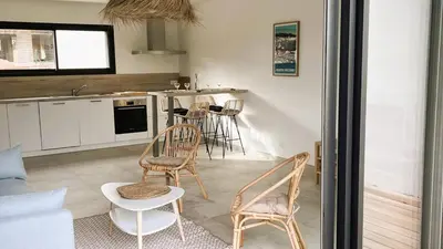 a kitchen with two chairs and a table in a room at Villa Copines, 4 pers, piscine chauffée, 5 mn plage in Cirendinu
