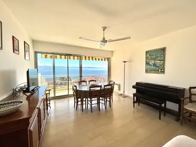 a living room with a table and a piano at Appartement L'Aiglon 1 centre-ville Ajaccio in Ajaccio