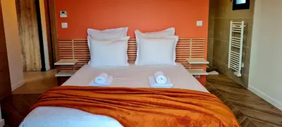 a bed with a pair of shoes sitting on it at Casa di Famiglia - Maison 3 chambres, piscine - Classée 4 étoiles in Figari