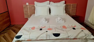 a bed with shoes sitting on top of it at Casa di Famiglia - Maison 3 chambres, piscine - Classée 4 étoiles in Figari