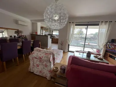 a living room with a couch and a chandelier at APPARTEMENT STANDING AJACCIO 5mn A PIEDS PLAGE DU RICANTO AJACCIO in Ajaccio