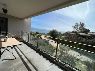 a balcony with a view of the water at APPARTEMENT STANDING AJACCIO 5mn A PIEDS PLAGE DU RICANTO AJACCIO in Ajaccio