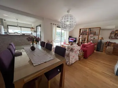 a living room with a table and a dining room at APPARTEMENT STANDING AJACCIO 5mn A PIEDS PLAGE DU RICANTO AJACCIO in Ajaccio